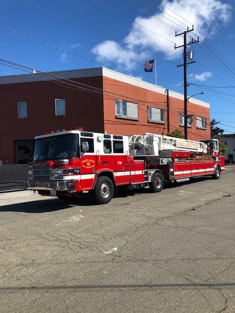 Oakland Fire Department T6 Pierce ladder truck photographed in profile.