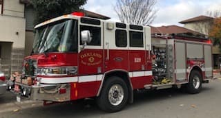 Oakland Fire Department Pierce Quantum Type I engine parked curbside.